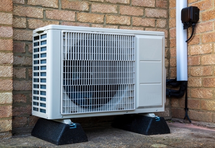 Single Heat pump outside of a modern house for air conditioning.