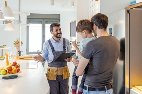 father and son talking with HVAC technician