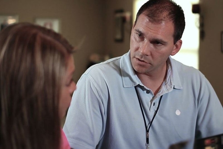 HVAC technician talking with customer