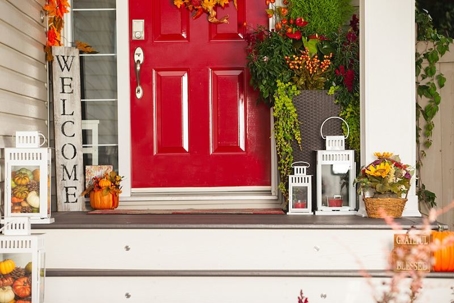 a red door with a welcome sign