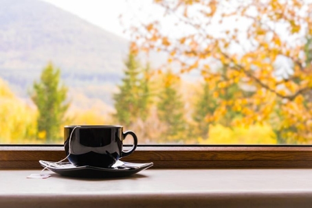 a cup of tea next to a window