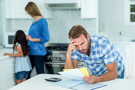 A man looking at a heating bill.